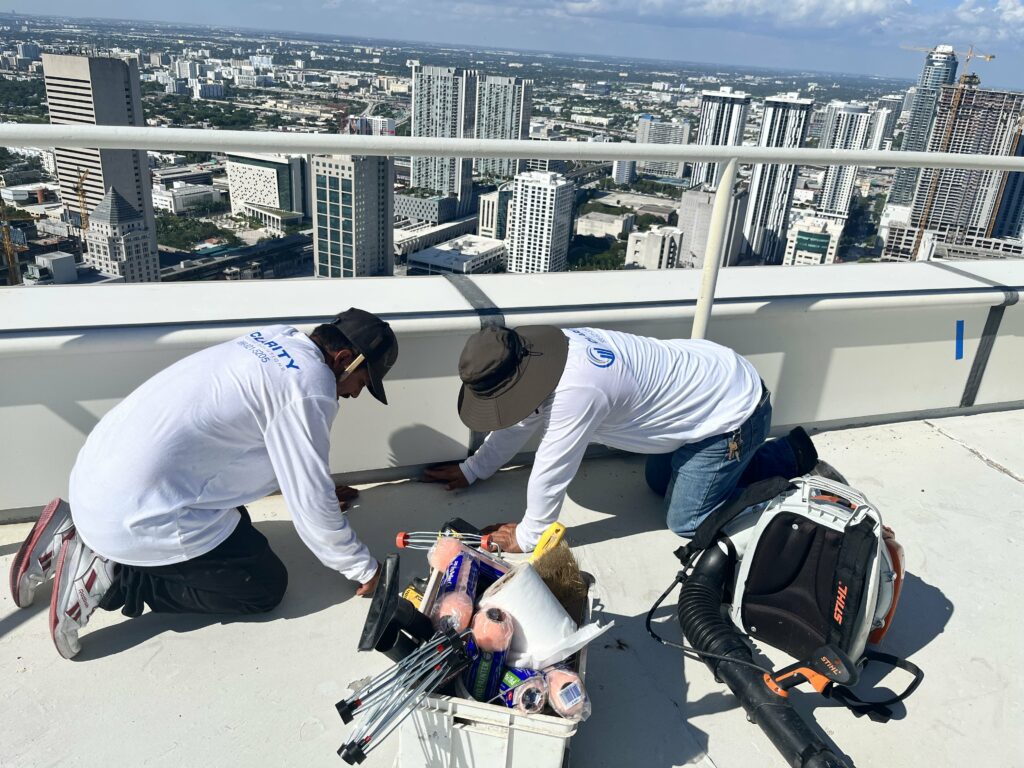 Clarity Roofing technician responding to an emergency roof situation high above the South Florida skyline