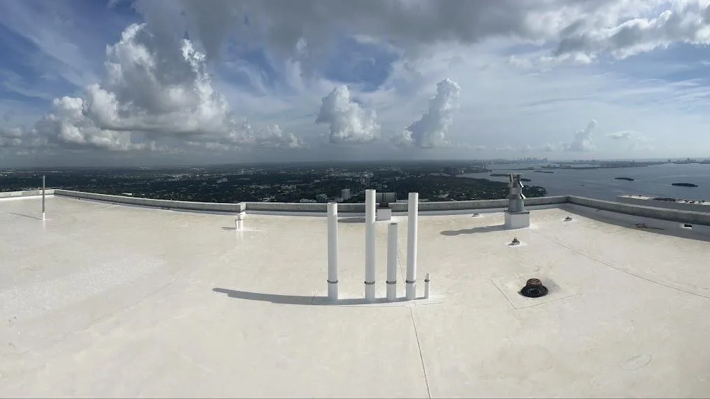 Finished white roof coating on a high-rise commercial roof